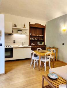 a kitchen with a table and chairs in a room at Casa Pellico in Turin