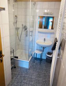 a bathroom with a shower and a sink and a shower at Ferienhaus Sommer in Pfronten