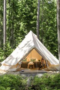 a large tent in the middle of a forest at Tahlo Luxury Tent Glamping in Mutala