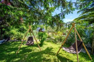 two hammocks sitting in the grass in a yard at Le Bassin du Tertre in Fronsac