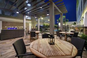 a patio with tables and chairs and a bar at Hilton Garden Inn Houston Medical Center, TX in Houston
