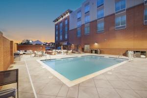 a large swimming pool in front of a building at Hampton Inn Greer Greenville, Sc in Greer