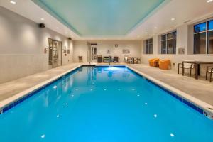 a large swimming pool with blue water in a building at Homewood Suites By Hilton Columbus Easton, Oh in Columbus