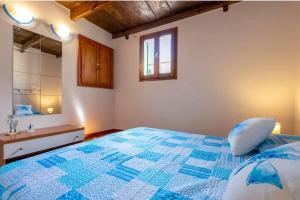Un dormitorio con una cama azul y blanca y un lavabo en Apartment Cavour, en Alghero