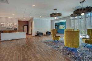 an office lobby with yellow chairs and a reception desk at Hampton Inn & Suites Sunnyvale-Silicon Valley, Ca in Sunnyvale