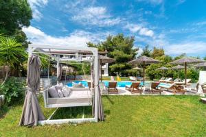 a backyard with a gazebo and a pool at Margi House in Skiathos Town