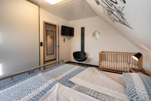 a bedroom with a bed and a crib in it at Koch 2 in Dahme