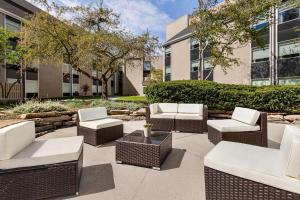 a patio with wicker chairs and tables in front of a building at Doubletree By Hilton Columbus Dublin in Dublin
