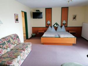 a hotel room with a bed and a couch at Apartments Rauter in Annenheim