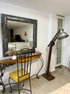 a room with a desk with a mirror and a lamp at ronit's place in Qiryat Shemona +15 photos