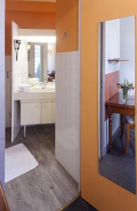 a bathroom with a sink and a mirror at Au Relais du Porhoet in Guilliers