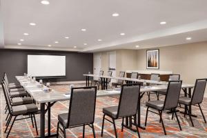 a conference room with tables and chairs and a projection screen at Doubletree By Hilton Columbus Dublin in Dublin