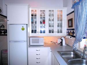 波塔萊格雷的住宿－Casa no Campo T3 e Piscina de PortusAlacer，厨房配有白色橱柜和白色冰箱。