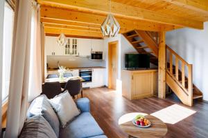 a living room with a couch and a table at Chaty Vážka in Štiavnické Bane