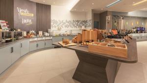 a large kitchen with a counter in a restaurant at Hampton by Hilton Konstanz in Konstanz