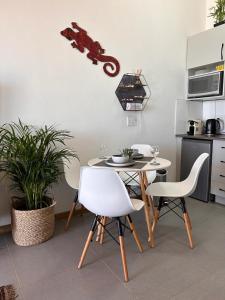 a kitchen with a table and chairs in a kitchen at Relax,Revive,Reset & enjoy the sounds of the sea! in Cape Town