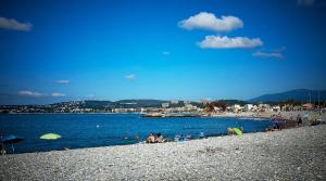 a group of people on a beach near the water at Nice House Rent in Saint-Laurent-du-Var