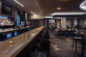 a bar in a restaurant with tables and chairs at DoubleTree by Hilton Silver Spring Washington DC North in Silver Spring