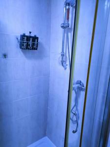 a bathroom with a shower with a glass door at Homestay BedSpace in Birmingham