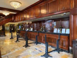 a bar in a room with wood paneling at The Benson Portland, Curio Collection by Hilton in Portland