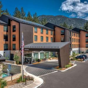 a hotel with a parking lot in front of a building at Hampton Inn & Suites South Lake Tahoe in South Lake Tahoe
