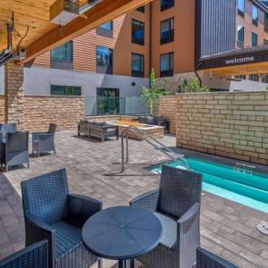 a patio with chairs and a table and a pool at Hampton Inn & Suites South Lake Tahoe in South Lake Tahoe