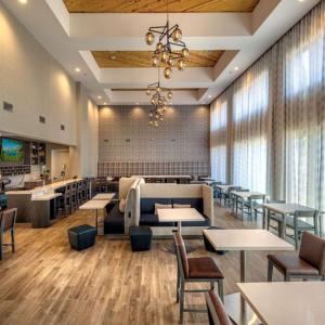 a dining room with tables and chairs and a restaurant at Hampton Inn & Suites South Lake Tahoe in South Lake Tahoe