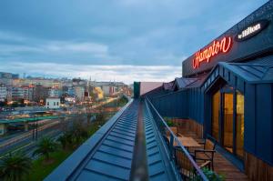 a building with a blue roof with a view of a city at Hampton By Hilton Istanbul Old City in Istanbul +32 photos