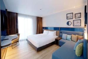 a hotel room with a bed and a couch at Hampton By Hilton Istanbul Old City in Istanbul