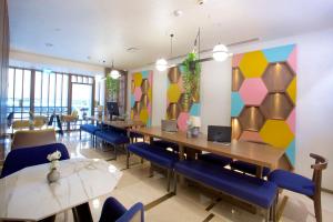 a restaurant with tables and chairs and a colorful wall at Hampton By Hilton Istanbul Old City in Istanbul