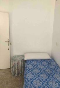 a small bedroom with a bed and a table at Nice flat.Very near UCAM, UM university.Murcia in Espinardo