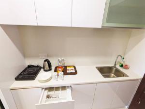 a small kitchen with a sink and a counter at Lovina 20-12A Formosa Residence in Nagoya