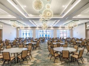 a room with tables and chairs and chandeliers at Homewood Suites By Hilton Toledo Downtown in Toledo