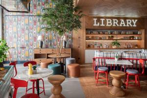 a restaurant with tables and chairs and a library at Se Catedral Hotel Porto, Tapestry Collection By Hilton in Porto