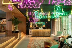 a restaurant with a bar with neon lights at Se Catedral Hotel Porto, Tapestry Collection By Hilton in Porto