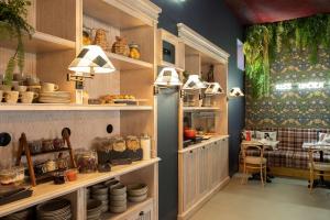 a kitchen with lots of shelves and a table at Se Catedral Hotel Porto, Tapestry Collection By Hilton in Porto