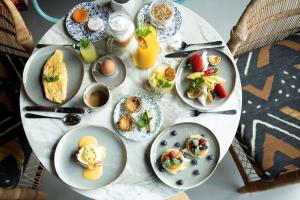 a white table with plates of food on it at Se Catedral Hotel Porto, Tapestry Collection By Hilton in Porto