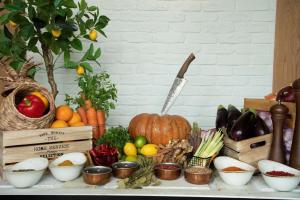 a table topped with lots of fruits and vegetables at Se Catedral Hotel Porto, Tapestry Collection By Hilton in Porto