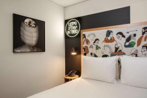 a bedroom with a bed and a poster with an owl at Se Catedral Hotel Porto, Tapestry Collection By Hilton in Porto