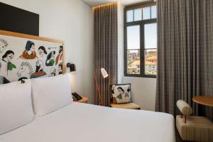 a hotel room with a bed and a window at Se Catedral Hotel Porto, Tapestry Collection By Hilton in Porto