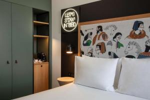 a bed with a head board with a sign above it at Se Catedral Hotel Porto, Tapestry Collection By Hilton in Porto