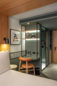 a bedroom with a table and a chair in a room at Se Catedral Hotel Porto, Tapestry Collection By Hilton in Porto
