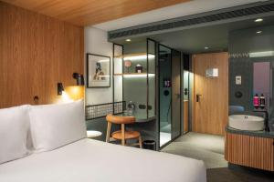 a hotel room with a bed and a bathroom at Se Catedral Hotel Porto, Tapestry Collection By Hilton in Porto