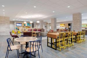 a lobby with tables and chairs and a waiting room at Home2 Suites By Hilton Richmond Short Pump in Richmond