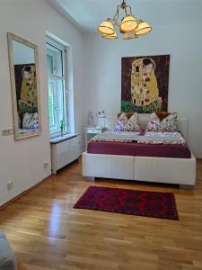 a bedroom with a bed with a mirror and a rug at City Apartment am Lendkanal, Klagenfurt in Klagenfurt