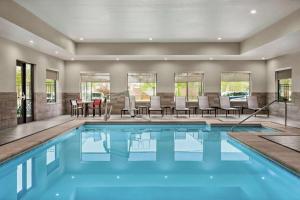 einen Pool mit Stühlen und einem Tisch in der Unterkunft Homewood Suites By Hilton Springfield Medical District in Springfield