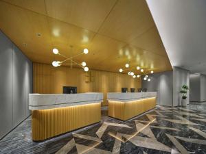a lobby with two reception desks in a building at Hilton Garden Inn Huzhou Anji Phoenix Mountain in Anji