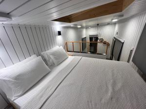 a bedroom with a large white bed in a room at Grenadine Lodge in Dalyan