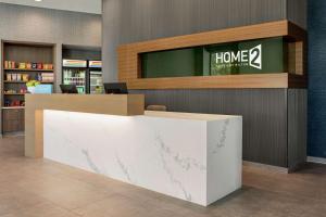 a lobby with a home sign on the wall at Home2 Suites By Hilton Minneapolis University Area in Minneapolis