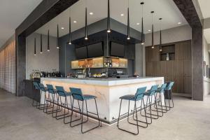 a bar with blue bar stools in a room at Home2 Suites By Hilton Minneapolis University Area in Minneapolis